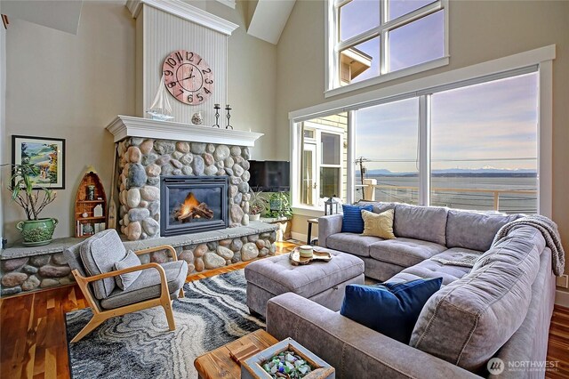 656 Lehman Dr, Camano Island, WA 98282 - living area with wood finished floors, a towering ceiling, and a fireplace