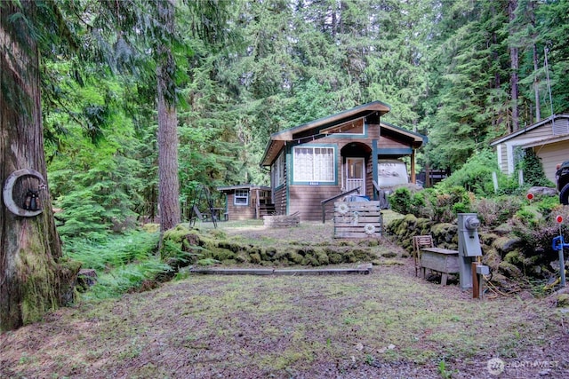 44664 Similk Trl, Concrete, WA 98237 - view of front of house with a view of trees and an outdoor structure