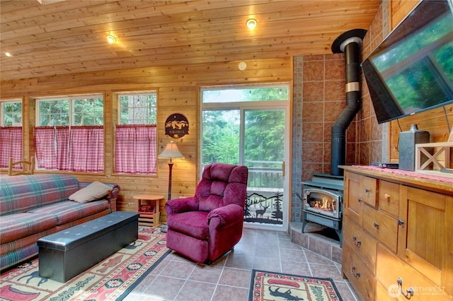 44664 Similk Trl, Concrete, WA 98237 - living area with a wood stove, light tile patterned floors, wood ceiling, and wooden walls