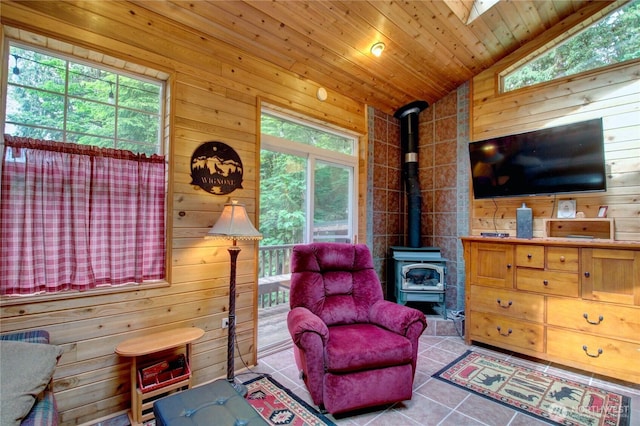 44664 Similk Trl, Concrete, WA 98237 - sitting room with vaulted ceiling, a wood stove, wood walls, and tile patterned floors