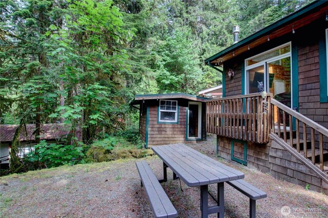 44664 Similk Trl, Concrete, WA 98237 - wooden deck with a storage unit, a wooded view, and stairway