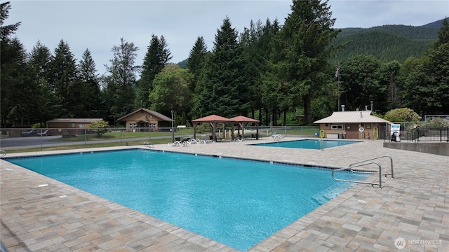 44664 Similk Trl, Concrete, WA 98237 - community pool featuring a patio area, a gazebo, and a wooded view