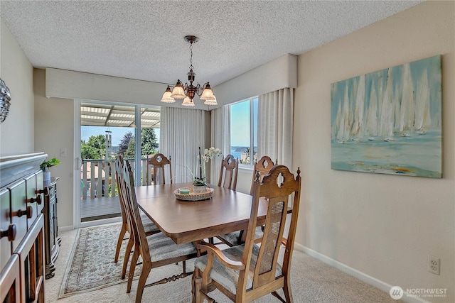 1728 N James St, Tacoma, WA 98406 - dining area featuring a chandelier, light colored carpet, and a textured ceiling