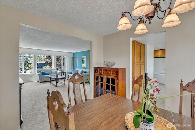 1728 N James St, Tacoma, WA 98406 - dining room featuring a textured ceiling, a chandelier, and light colored carpet