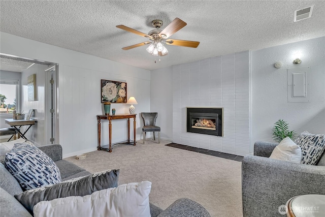 1728 N James St, Tacoma, WA 98406 - carpeted living area featuring electric panel, ceiling fan, a tiled fireplace, and a textured ceiling