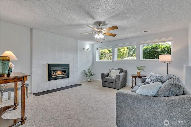 1728 N James St, Tacoma, WA 98406 - living room with carpet floors, ceiling fan, a fireplace, and a textured ceiling