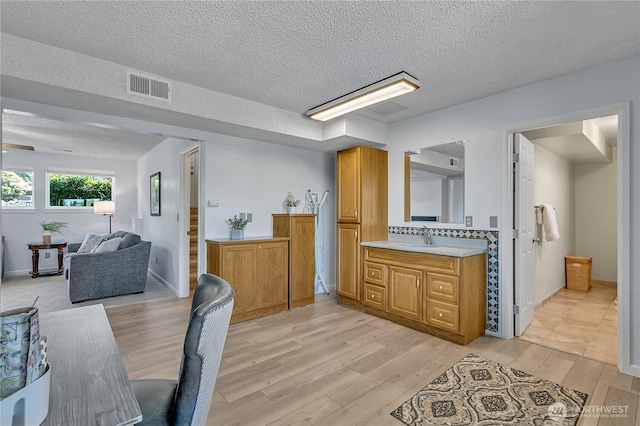 1728 N James St, Tacoma, WA 98406 - dining area with light wood-style flooring, a textured ceiling, and stairway