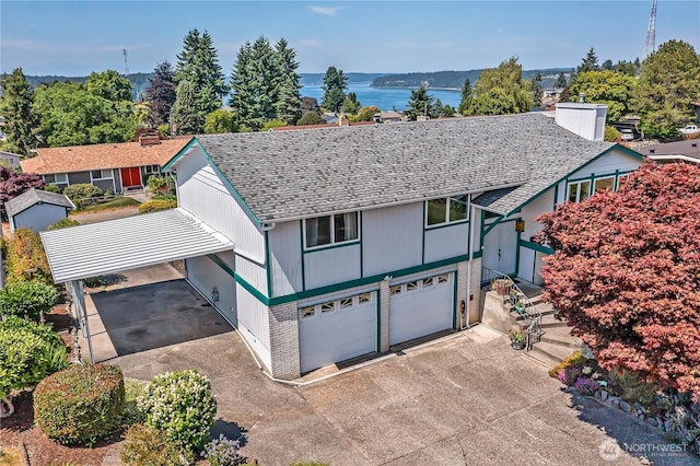 1728 N James St, Tacoma, WA 98406 - tudor-style house with roof with shingles, concrete driveway, a garage, a carport, and brick siding
