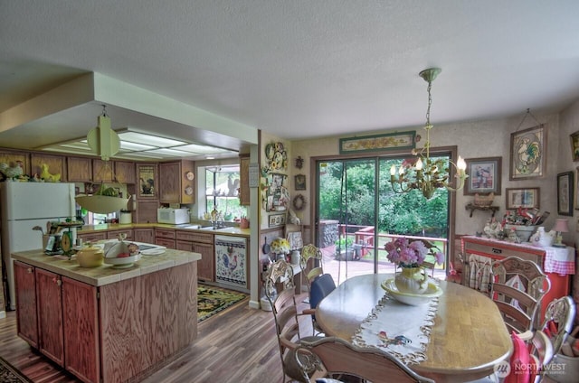 13273 W Cloquallum Rd, Elma, WA 98541 - dining room featuring wood finished floors, a textured ceiling, and a chandelier