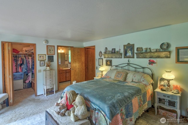 13273 W Cloquallum Rd, Elma, WA 98541 - bedroom with light colored carpet, a closet, a walk in closet, and ensuite bathroom
