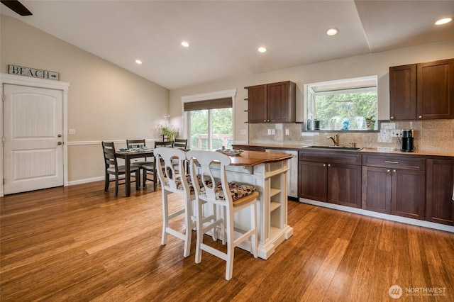 755 Island Cir SE, Ocean Shores, WA 98569 - kitchen with dishwasher, lofted ceiling, wood finished floors, backsplash, and open shelves