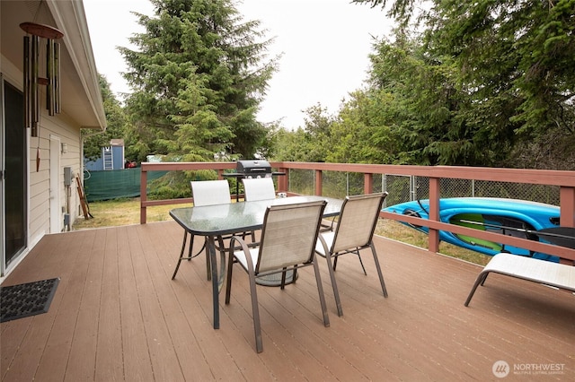 755 Island Cir SE, Ocean Shores, WA 98569 - wooden deck featuring outdoor dining space and a grill