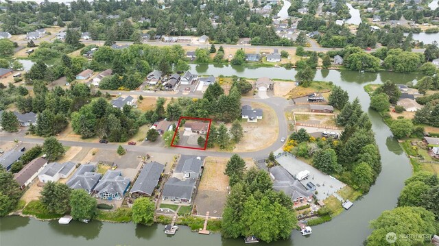 755 Island Cir SE, Ocean Shores, WA 98569 - aerial view of residential area featuring property parcel outlined and a large body of water