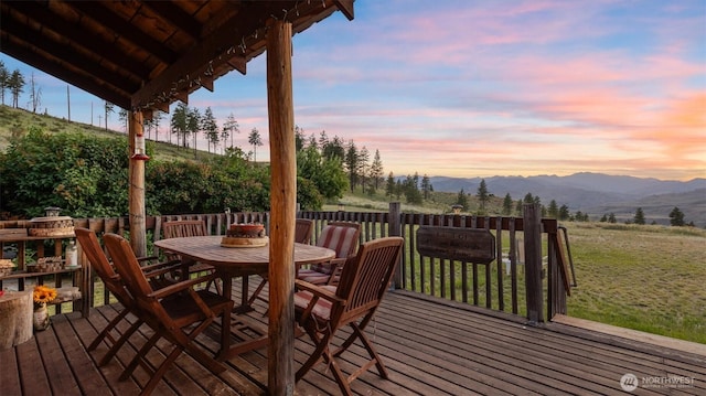 767 Bill Shaw Rd, Pateros, WA 98846 - deck with outdoor dining area, a mountain view, and a yard