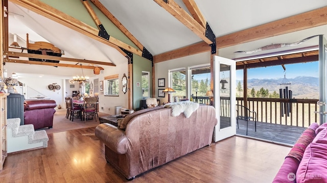 767 Bill Shaw Rd, Pateros, WA 98846 - living room with beam ceiling, a mountain view, high vaulted ceiling, wood finished floors, and a chandelier