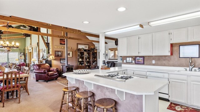 767 Bill Shaw Rd, Pateros, WA 98846 - kitchen featuring white appliances, light countertops, white cabinetry, a breakfast bar, and open floor plan