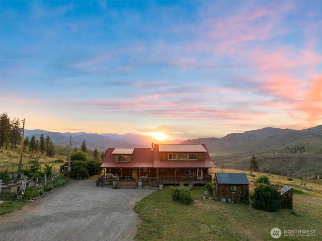 767 Bill Shaw Rd, Pateros, WA 98846 - chalet / cabin with a shed, a mountain view, driveway, covered porch, and a metal roof