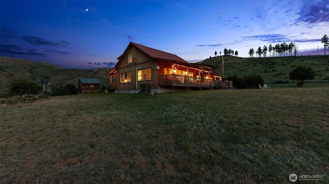 767 Bill Shaw Rd, Pateros, WA 98846 - property exterior at dusk featuring a lawn and a deck