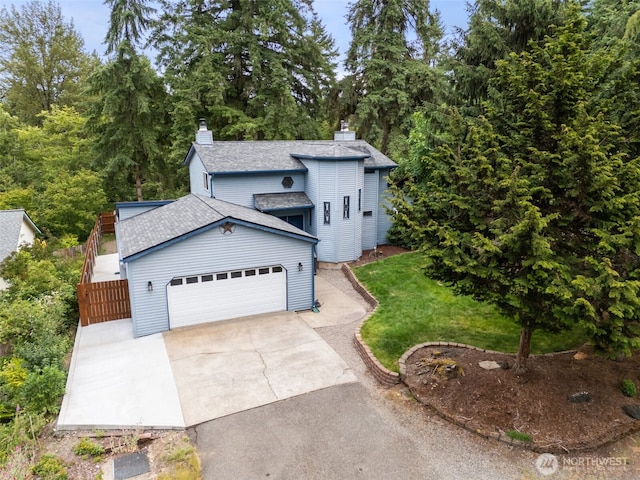 8037 Incline Dr SE, Olympia, WA 98513 - view of front of house featuring driveway, a chimney, an attached garage, roof with shingles, and a front lawn