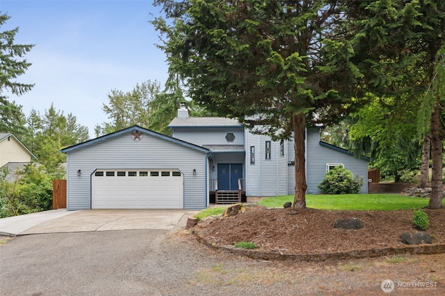 8037 Incline Dr SE, Olympia, WA 98513 - view of front of property with asphalt driveway, a garage, and a chimney
