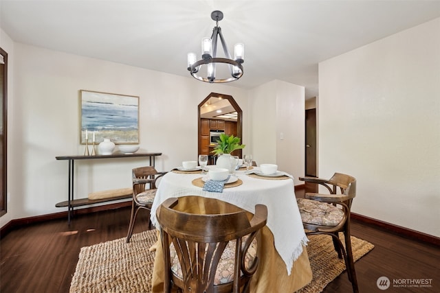8037 Incline Dr SE, Olympia, WA 98513 - dining room featuring a chandelier, arched walkways, and dark wood-type flooring