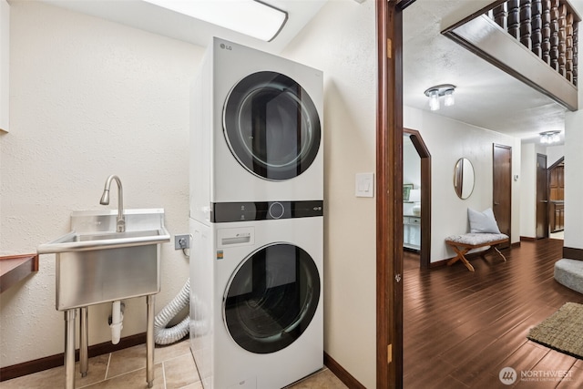 8037 Incline Dr SE, Olympia, WA 98513 - washroom with stacked washer / drying machine, a textured wall, wood finished floors, and arched walkways