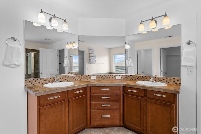 18328 73rd Avenue Ct E, Puyallup, WA 98375 - bathroom featuring double vanity, a shower with door, and tasteful backsplash