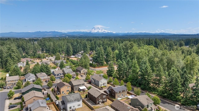 18328 73rd Avenue Ct E, Puyallup, WA 98375 - aerial perspective of suburban area with a heavily wooded area and mountains