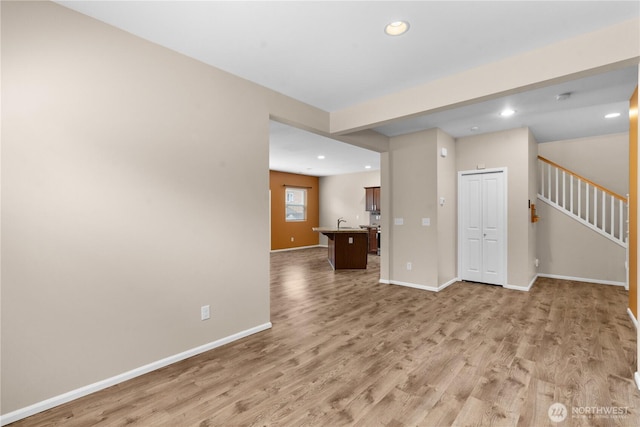 18328 73rd Avenue Ct E, Puyallup, WA 98375 - unfurnished living room featuring light wood finished floors, recessed lighting, and stairway