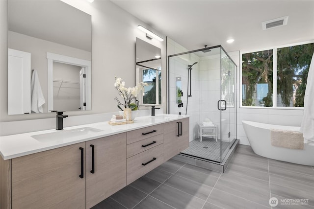 1313 14th Ave S Unit B, Seattle, WA 98144 - full bathroom featuring double vanity, a shower stall, a soaking tub, and tile patterned flooring