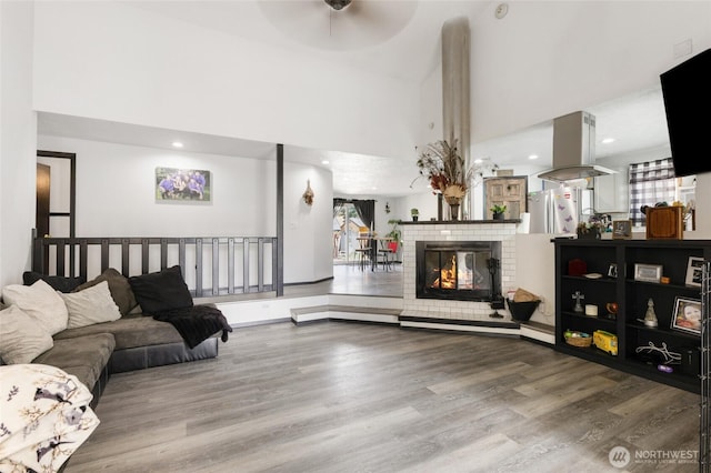 9307 Albert Way SE, Moses Lake, WA 98837 - living area with wood finished floors, a towering ceiling, ceiling fan, a fireplace, and recessed lighting