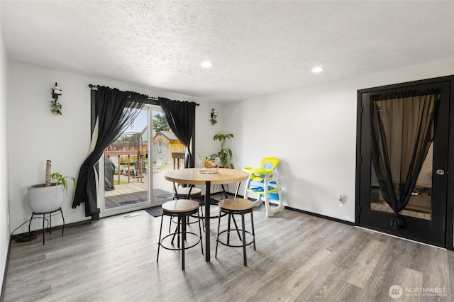 9307 Albert Way SE, Moses Lake, WA 98837 - dining space with wood finished floors, a textured ceiling, and recessed lighting