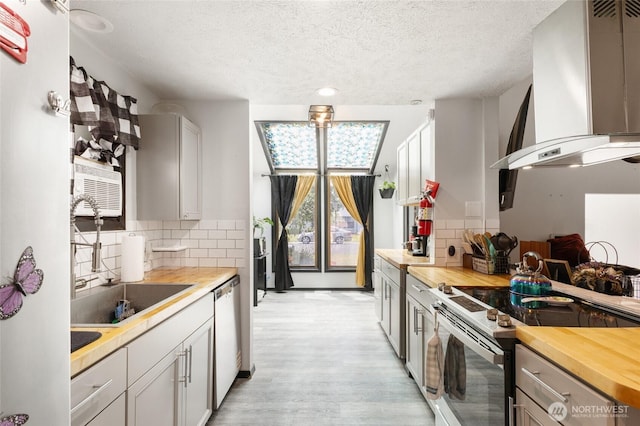 9307 Albert Way SE, Moses Lake, WA 98837 - kitchen featuring stainless steel electric stove, wall chimney range hood, butcher block countertops, dishwasher, and a textured ceiling