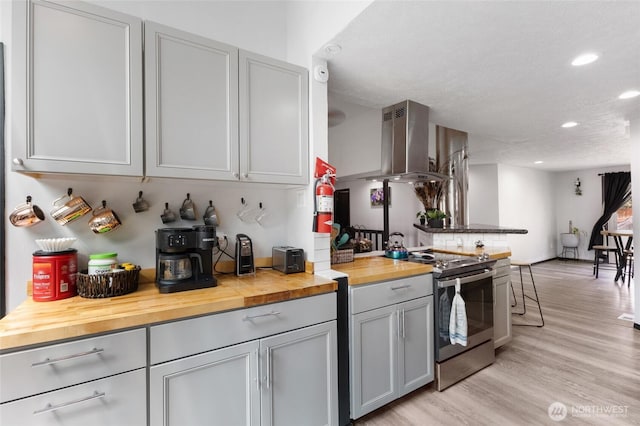 9307 Albert Way SE, Moses Lake, WA 98837 - kitchen featuring stainless steel electric stove, wooden counters, ventilation hood, gray cabinets, and recessed lighting