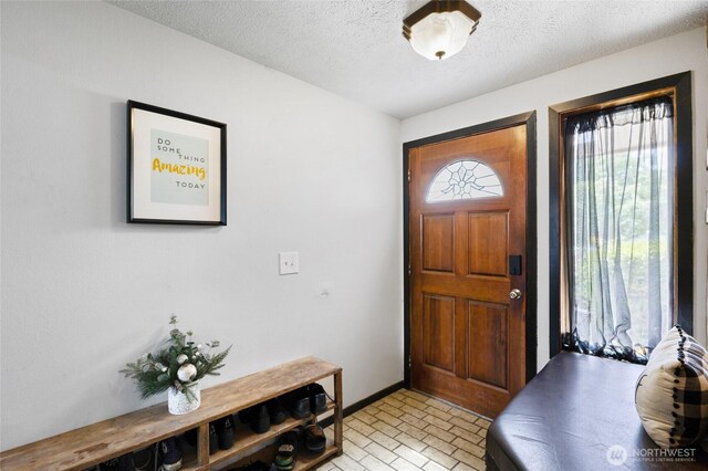 9307 Albert Way SE, Moses Lake, WA 98837 - entryway with brick patterned floors and a textured ceiling