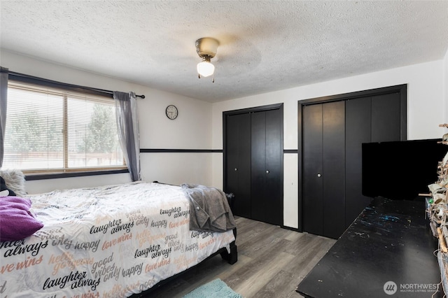 9307 Albert Way SE, Moses Lake, WA 98837 - bedroom with multiple closets, wood finished floors, a textured ceiling, and ceiling fan