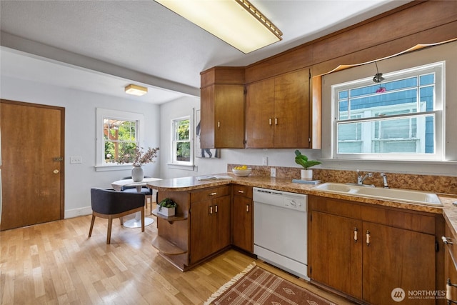 4335 Fawcett Ave, Tacoma, WA 98418 - kitchen with white dishwasher, light wood-style flooring, and brown cabinetry