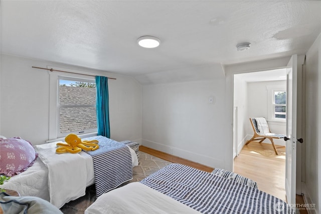 4335 Fawcett Ave, Tacoma, WA 98418 - bedroom featuring light wood-type flooring, a textured ceiling, and vaulted ceiling