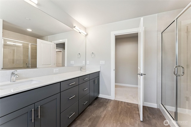 13936 178th St E Unit 85, Puyallup, WA 98374 - bathroom with double vanity, wood finished floors, and a shower stall