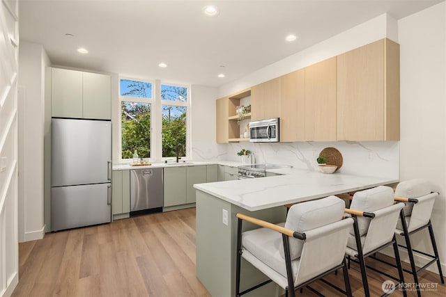 1615 N 50th St Unit A, Seattle, WA 98103 - kitchen with stainless steel appliances, a peninsula, open shelves, backsplash, and recessed lighting