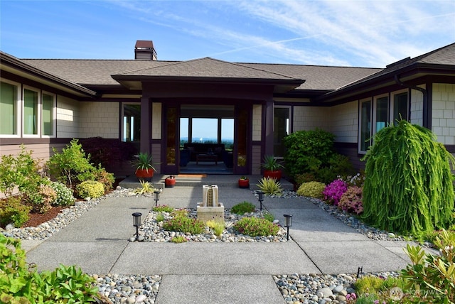 771 Brigadoon Blvd, Sequim, WA 98382 - view of exterior entry featuring a chimney and roof with shingles