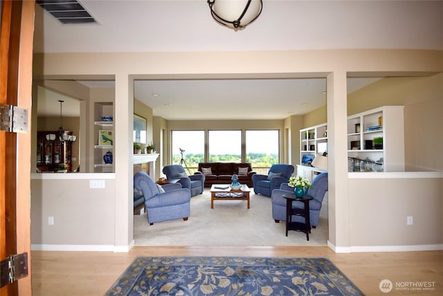 771 Brigadoon Blvd, Sequim, WA 98382 - living room with wood finished floors, a fireplace, and built in features