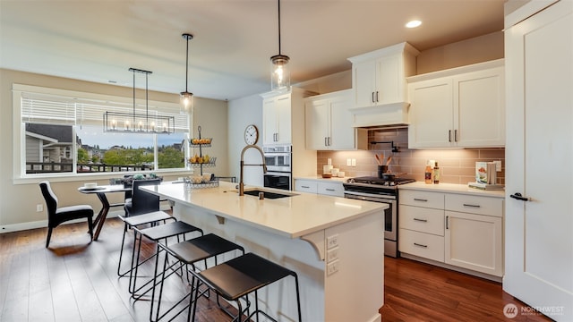 23000 SE Sycamore St, Black Diamond, WA 98010 - kitchen featuring stainless steel appliances, dark wood finished floors, tasteful backsplash, white cabinetry, and recessed lighting