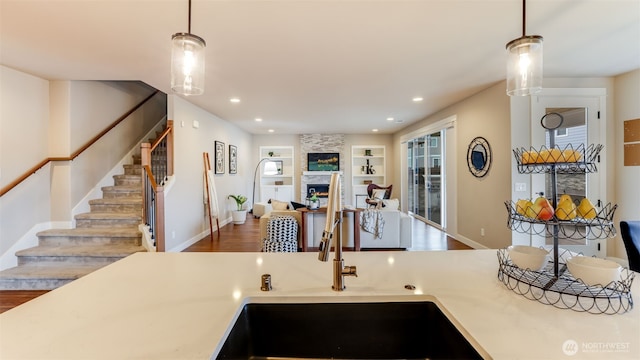 23000 SE Sycamore St, Black Diamond, WA 98010 - kitchen featuring wood finished floors, recessed lighting, decorative light fixtures, built in features, and open floor plan