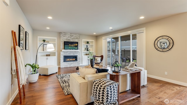 23000 SE Sycamore St, Black Diamond, WA 98010 - living room featuring a fireplace, built in features, wood finished floors, and recessed lighting