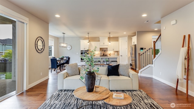23000 SE Sycamore St, Black Diamond, WA 98010 - living area featuring dark wood-style flooring, stairway, and recessed lighting