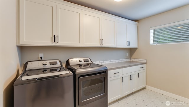 23000 SE Sycamore St, Black Diamond, WA 98010 - laundry room with washer and clothes dryer, cabinet space, and light floors