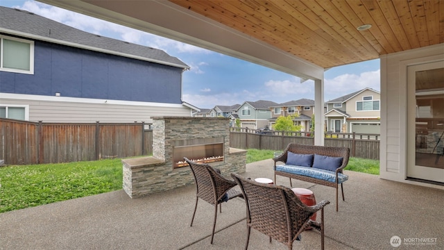 23000 SE Sycamore St, Black Diamond, WA 98010 - fenced backyard featuring a patio area, an outdoor living space with a fireplace, and a residential view