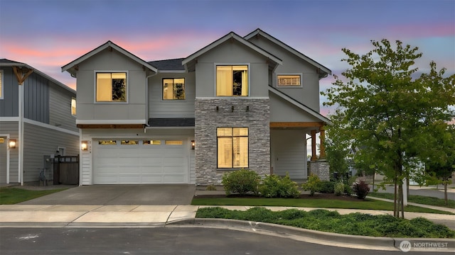 23000 SE Sycamore St, Black Diamond, WA 98010 - modern home featuring stone siding, driveway, and a garage