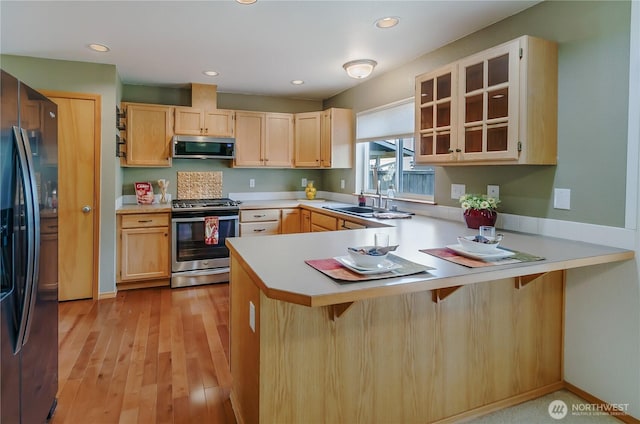 4101 Alabaster St SE, Lacey, WA 98503 - kitchen featuring stainless steel appliances, a peninsula, light countertops, glass insert cabinets, and recessed lighting